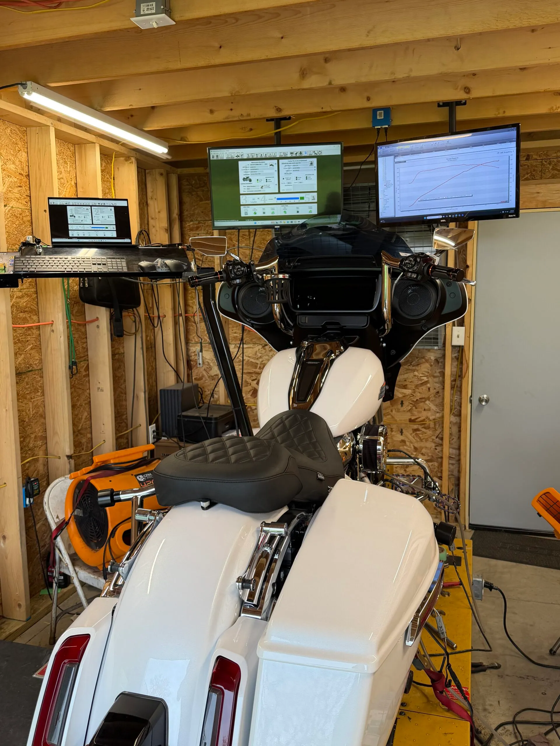 Harley-Davidson motorcycle strapped to the dynamometer in Frosty’s shop